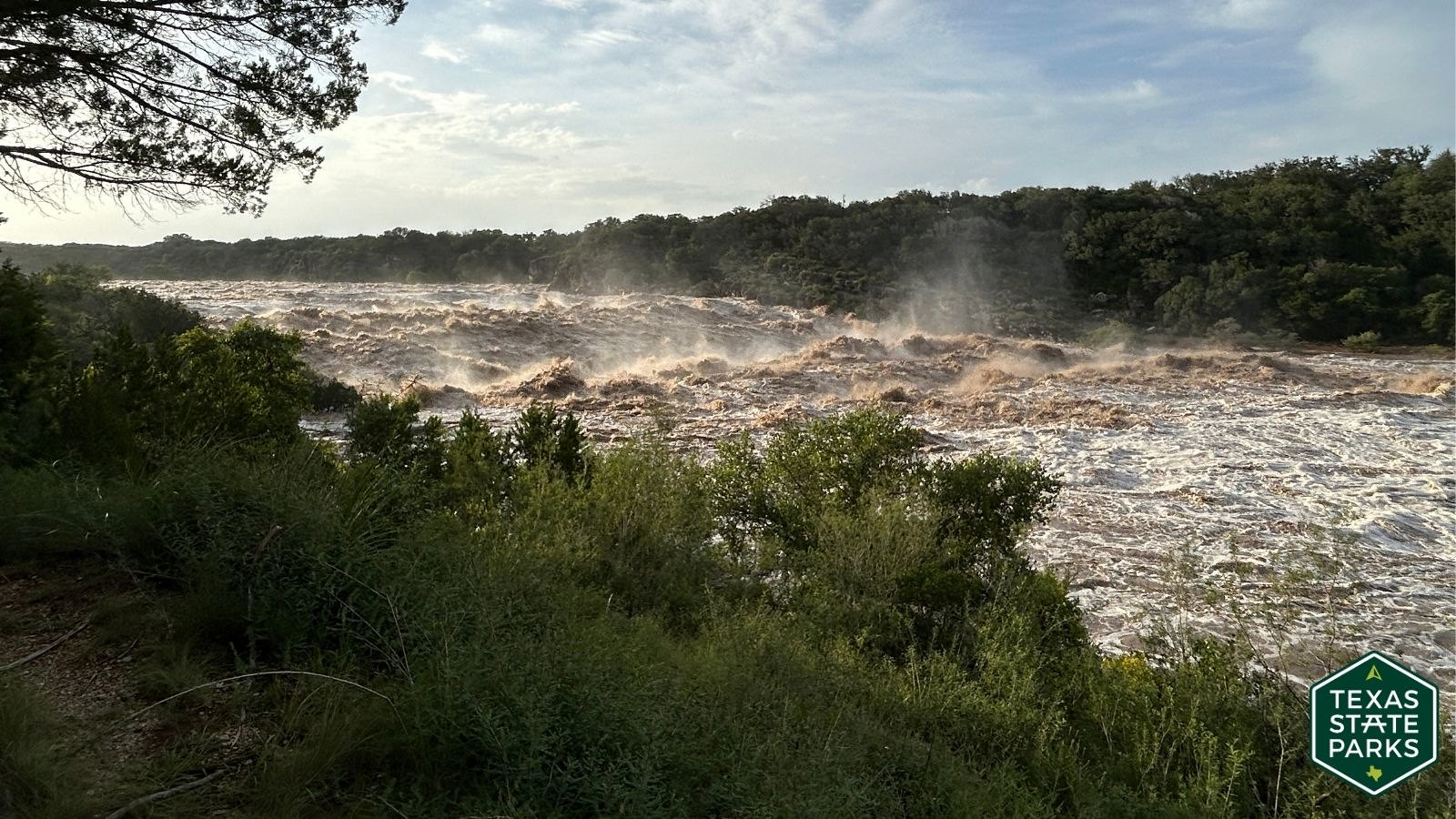 Floodwaters rushing through a Texas State Park following heavy rains in July 2026